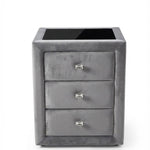 A small gray three-drawer nightstand or side table with a glossy black top surface and small silver drawer pulls.