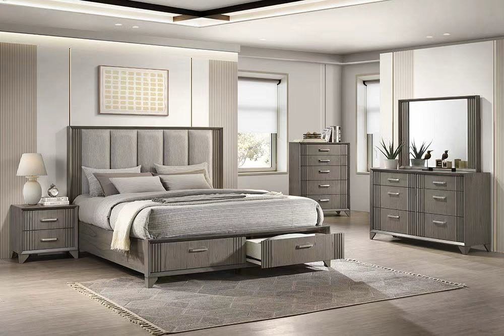 A modern bedroom furniture set in a warm gray finisha, including a bed frame with a padded headboard, a matching nightstand, a tall dresser, a mirror, and a rug, arranged in a bright, contemporary bedroom.